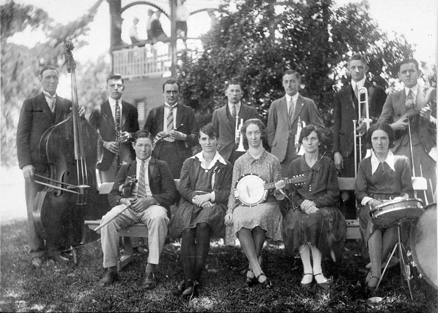 An orchestra of musicians performing outdoors