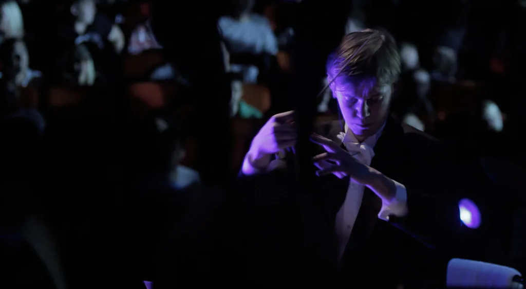 Conductor leading a symphony orchestra Conductor leading a symphony orchestra
