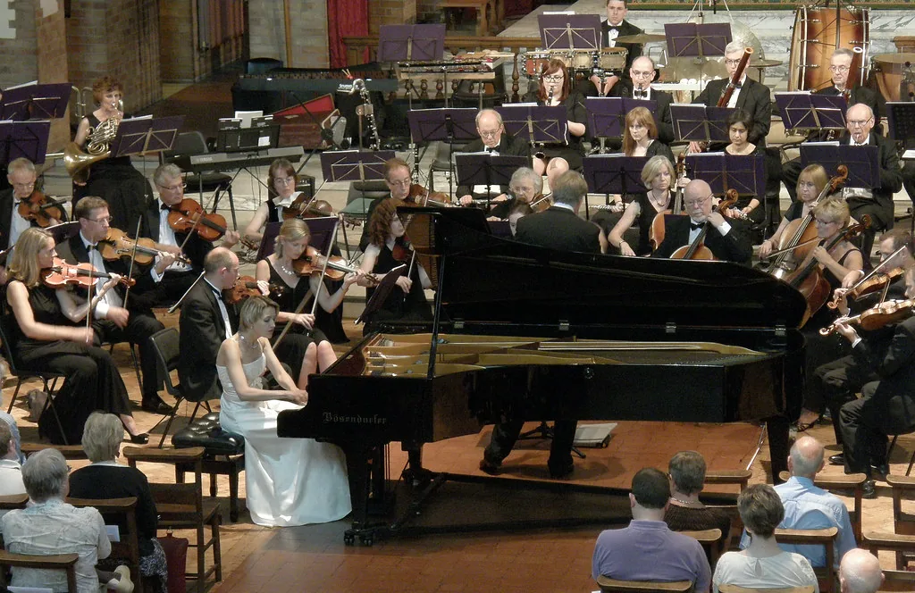 Classical orchestra in concert with a pianist Classical orchestra in concert with a pianist