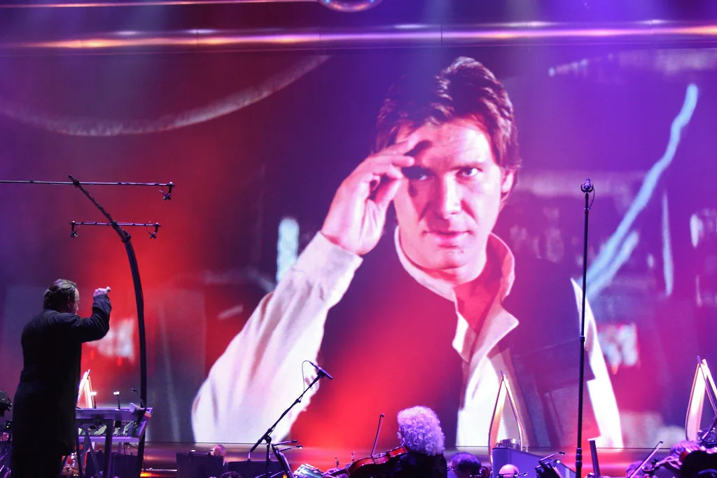 Conductor leading an orchestra in concert Conductor leading an orchestra in concert