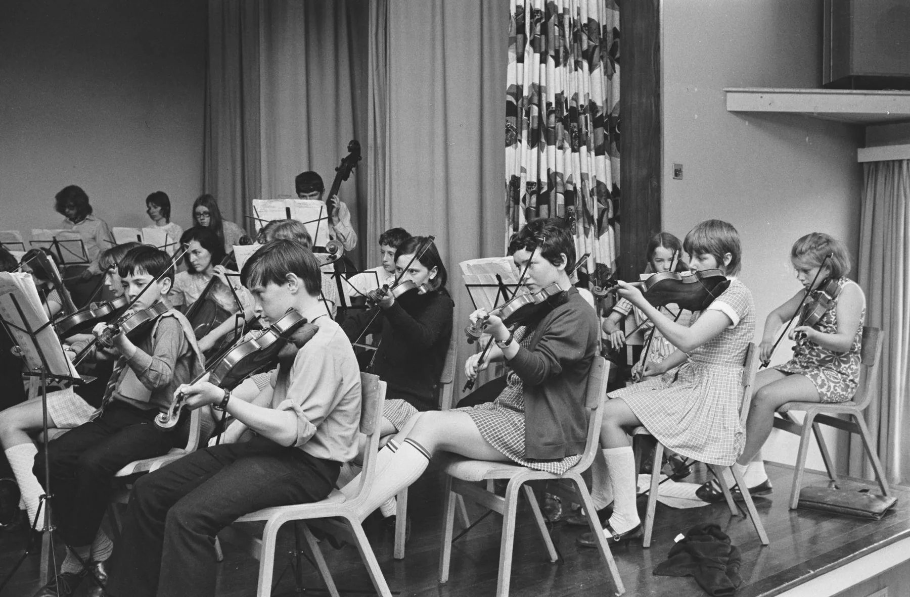 Young string orchestra in rehearsal