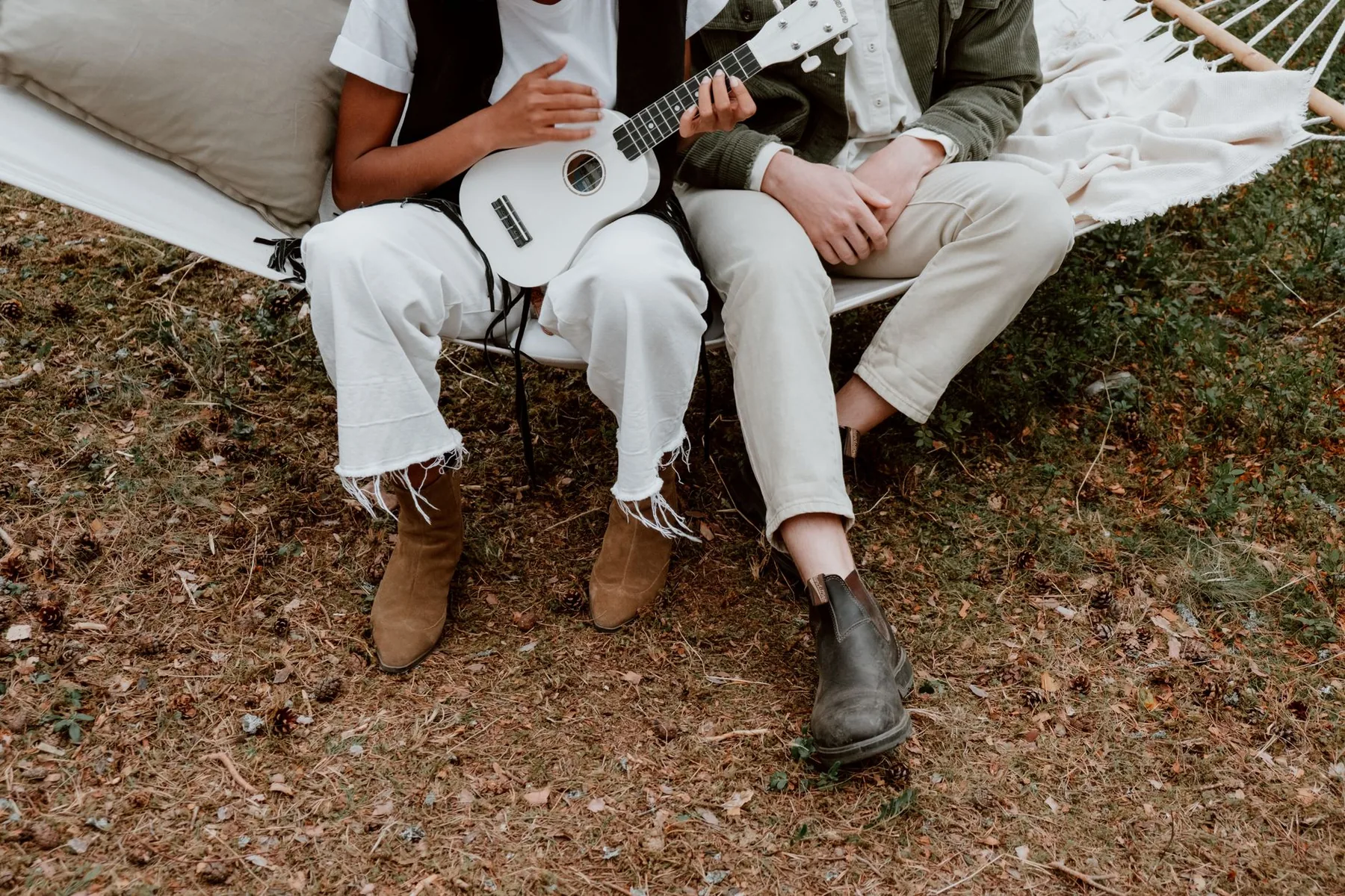 Couple playing the ukulele outdoors Couple playing the ukulele outdoors