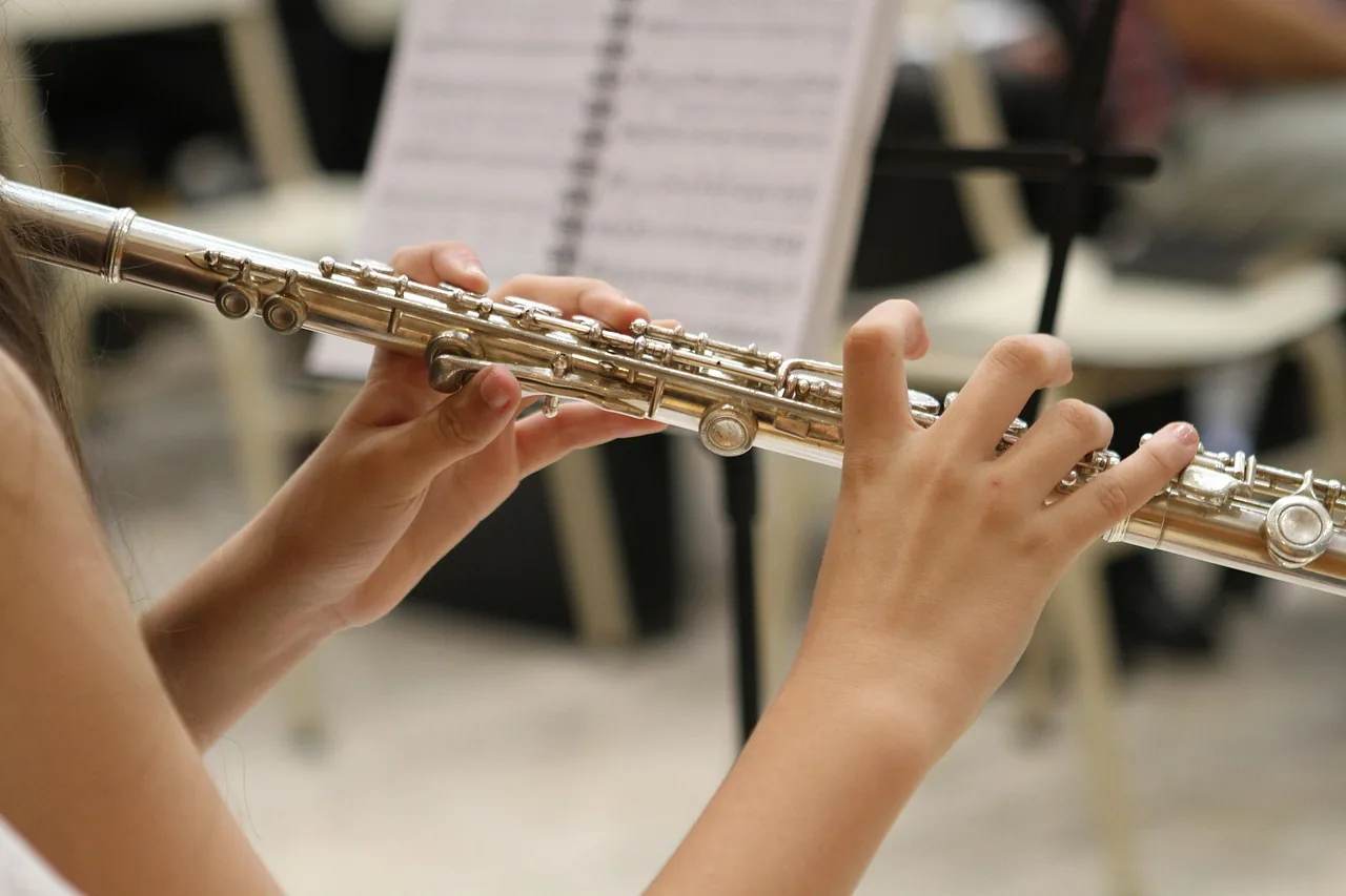 Flutist performing an orchestral score Flutist performing an orchestral score