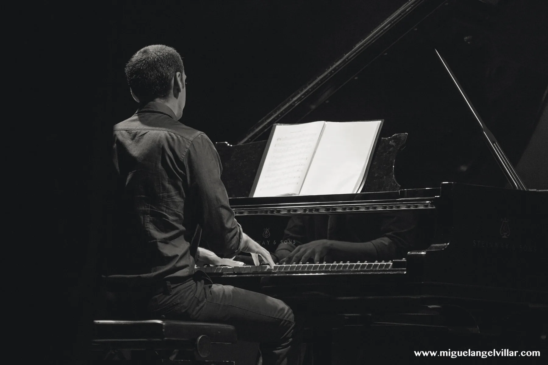 Pianist playing a Debussy score Pianist playing a Debussy score